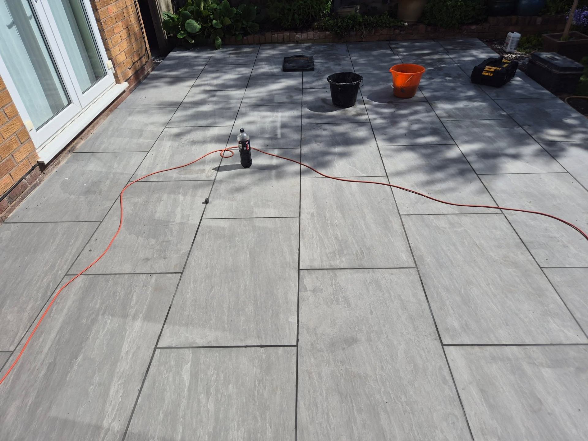 Freshly laid grey porcelain patio by JSB Paving